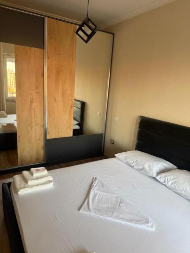 a bed in a room with a large mirror at B&B Tirane in Tirana