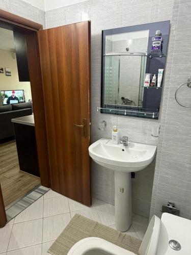 a bathroom with a sink and a toilet at B&B Tirane in Tirana