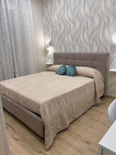 a bedroom with a bed with two pillows on it at The Superhost - Marekiaro in Crotone