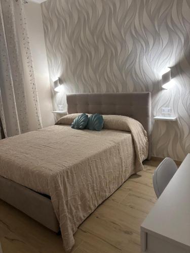 a bedroom with a bed with two pillows on it at The Superhost - Marekiaro in Crotone