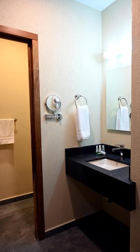 a bathroom with a black sink and a mirror at Casa Tita in Acámbaro