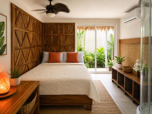 a bedroom with a large bed and a window at Sanctuary Puerto Viejo in Cocles