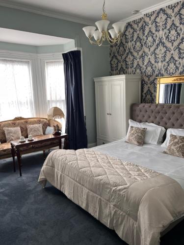 a bedroom with a large bed and a couch at Bray Head B&B in Bray