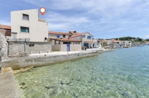 a view of the water in front of a building at Apartment Mirni by the sea in Prvić Luka