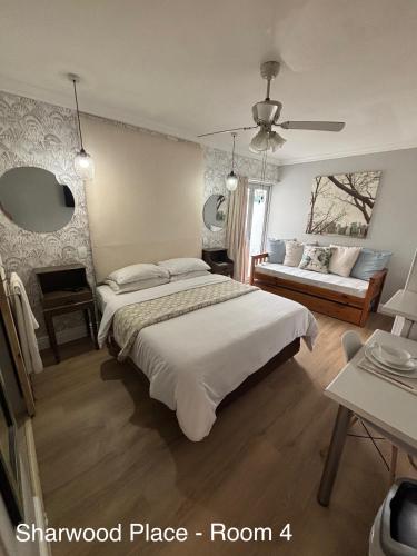 a bedroom with a large bed and a window at Sharwood Place in Port Elizabeth