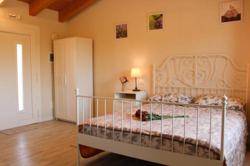 a bedroom with a bed with a white bed frame at Veneto Stay - Pool Loft in Abano Terme