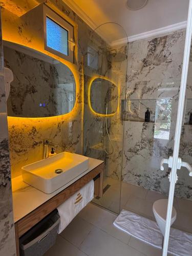 a bathroom with a sink and a shower at Villa Zen Oasis in Golem