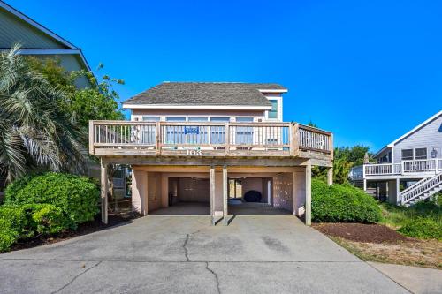 a house with a deck on top of a driveway at 6165 - Fantasy Land in Kill Devil Hills