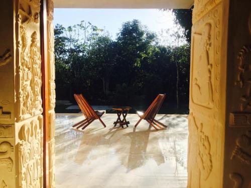 a view of a patio with two chairs and a table at Hotel Casa Maya Calakmul in Chicanna