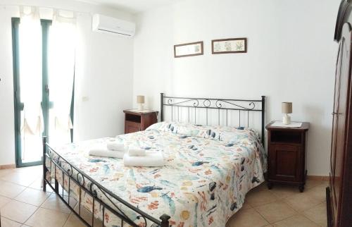 a bedroom with a bed with two towels on it at Pauli's apartment in Valledoria
