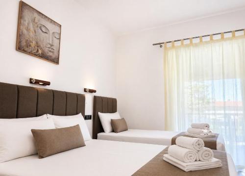 a hotel room with a bed and a window at H Stella Apartments & Rooms in Kalamitsi