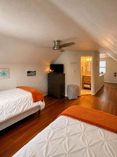 a bedroom with two beds and a ceiling fan at Serenity Landing in Sioux Falls