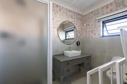 a bathroom with a sink and a mirror at Safi Luxury Self-Catering Suite 8 in East London