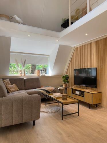a living room with a couch and a tv at Wonderwild C79, Dog Friendly in Lanaken