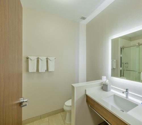 a white bathroom with a sink and a mirror at Holiday Inn Express & Suites Lindale - Tyler by IHG in Lindale