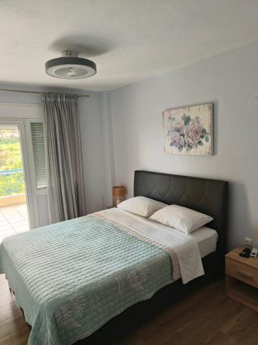 a bedroom with a large bed and a window at Pine Lodge in Kavála