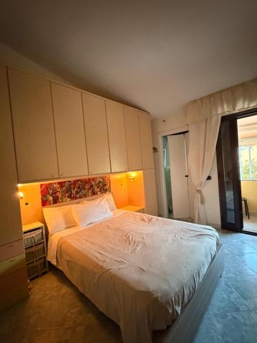a bedroom with a large bed with white sheets at B&B Is Pranus a Mari Casa Privata in Solanas