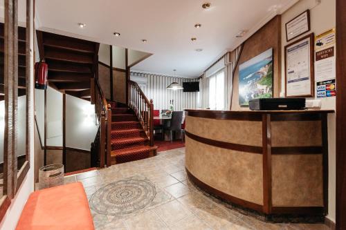 a lobby with a staircase and a reception desk at Pensión Zumardi in Deba