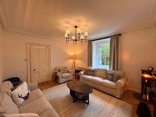 a living room with two couches and a table at Glenrigh House - Main Residence for 7 people in Onich