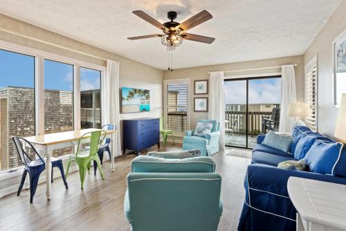 a living room with a blue couch and a table at C308B - Duck Tails in Duck
