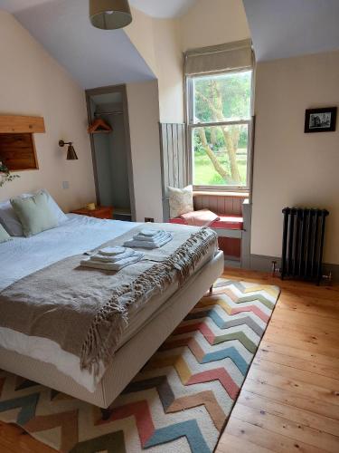 a bedroom with a bed and a rug on the floor at Jameswood Villa in Sandbank