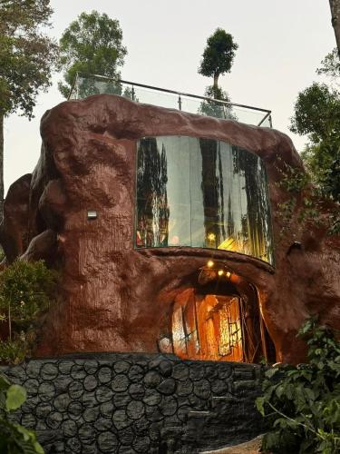 a tree house in the shape of a log at Rai’s Coorg Cave House in Madikeri