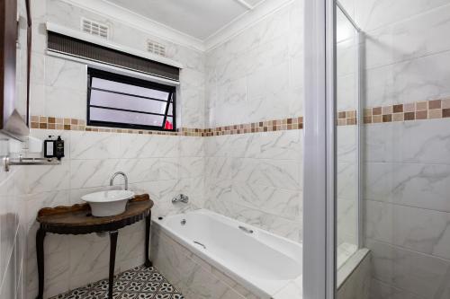 a bathroom with a tub and a sink and a shower at Safi Luxury Apartment 6 - 2 bedroom in East London