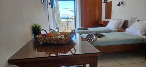 a room with a table with a basket of fruit on it at Sky Eye Studios in Kokkini Khanion