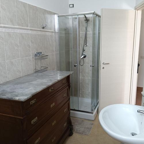 a bathroom with a shower and a sink and a tub at Villa Beregra in Lempa