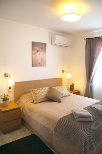 a bedroom with a bed with two pillows on it at Casa C Alcoutim in Alcoutim