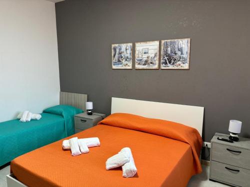 a bedroom with two beds with towels on them at Casa Vacanze del Salento in Sava