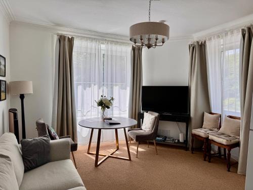 a living room with a couch and a table at Glenrigh House - The Garden Flat in Fort William