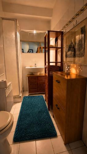 a bathroom with a toilet a sink and a rug at Home for 2 few steps from center of Monte Carlo in Beausoleil