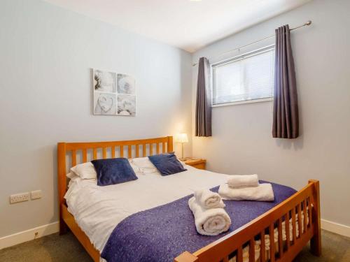 a bedroom with a bed with towels on it at 3 Bed in Kings Lynn oc-43259 in Dersingham