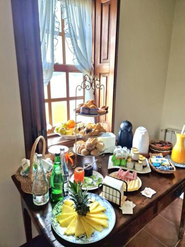 a table with many plates of food on it at Quinta do Pomarinho - Arouca in Arouca