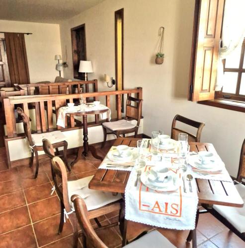 a dining room with a table and chairs at Quinta do Pomarinho - Arouca in Arouca