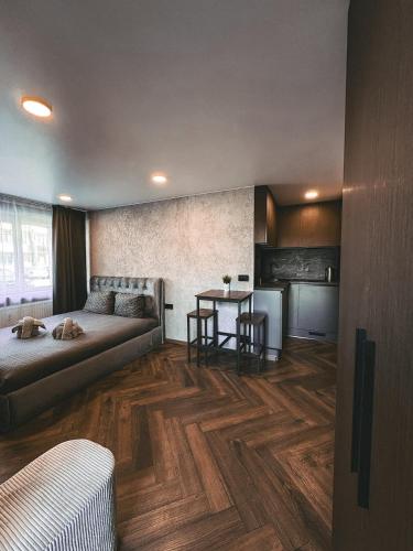 a living room with a couch and a table at Skersgatvio Apartmentai in Zarasai
