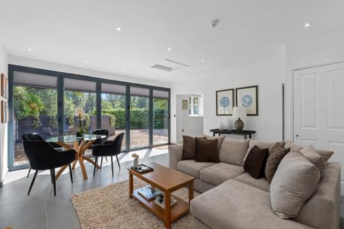 a living room with a couch and a table at Cadnam Lodge in Cadnam