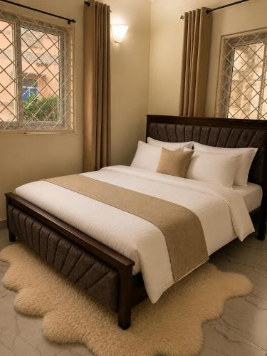 a large bed with white pillows in a bedroom at Iconic lux living in Malindi