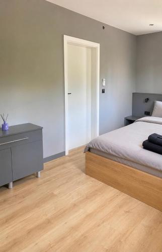 a bedroom with a bed and a dresser and a mirror at Platinum Apartment in Wałbrzych