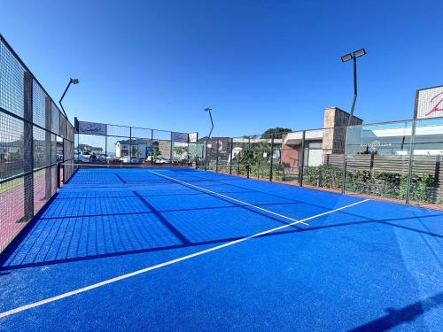 a tennis court with a net on top of it at Ocean's Edge Escape! in Ballito