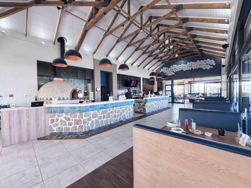 a restaurant with a bar in the middle of a room at Ocean's Edge Escape! in Ballito