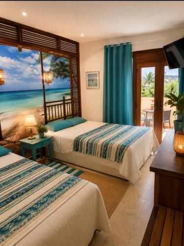 two beds in a room with a view of the ocean at Oliver Santiago Mallorca in Cala Figuera