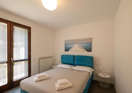 a bedroom with a bed with two towels on it at Casa Vacanze Costa del Sole in Riva di Solto