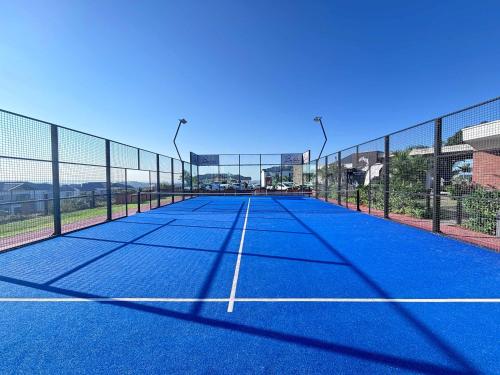 a tennis court with a net on top of it at Ocean Sunrise! in Ballito