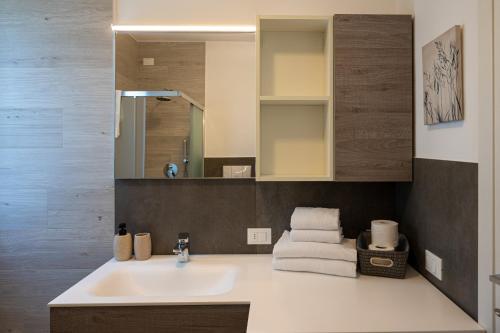 a bathroom with a sink and a mirror at Casa Vacanze Costa del Sole in Riva di Solto