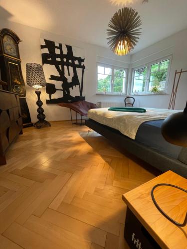 a bedroom with a large bed and a wooden floor at Schönste Location in Würzburg in Würzburg