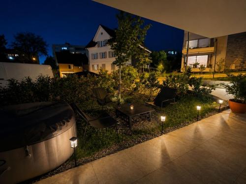 a garden with lights in the grass at night at Lux Line Apartment in Zurich