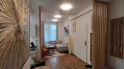 a living room with a couch and a table in a room at Kolonáda in Poděbrady