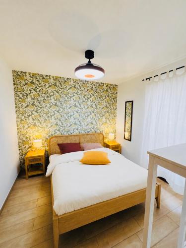 a bedroom with a bed and two night stands and a table at Casa Lulù in Cala Gonone